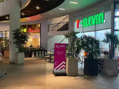 a mall with potted plants and a sign in it at Destina Stays @Air Residences Makati, MetroManila in Manila