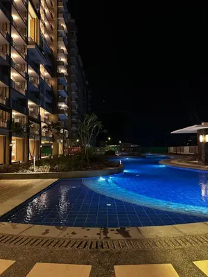 a swimming pool at night next to a building at Casa Chena in Manila