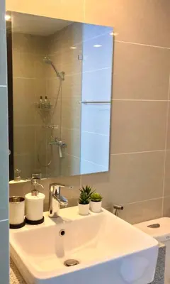 a bathroom with a sink and a mirror at New & Modern Cozy 1BR w/ Balcony@BGC, WiFi 300MBPS in Manila