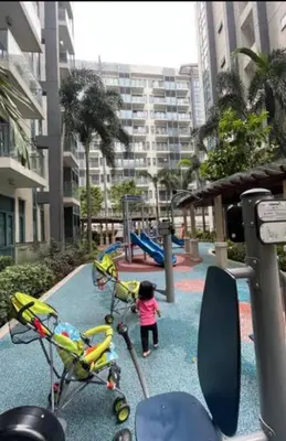 a little girl is playing in a playground at Nadzcondotel-2 Two Palmtree villas nearby NAIA Terminal 3 in Manila