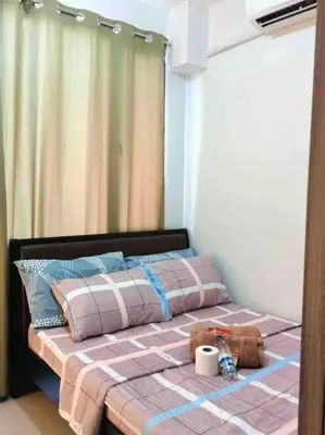 a bed with a teddy bear sitting on top of it at Shore 2 Staycation - Near Mall of Asia and Casinos in Manila