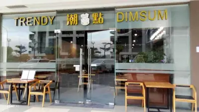 a restaurant with tables and chairs in front of a glass door at The SPLENDOR Comfortable living by Awsom Phil in Manila