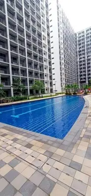 a swimming pool in front of two tall buildings at The SPLENDOR Comfortable living by Awsom Phil in Manila
