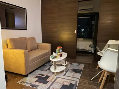 a living room with a couch and a table at Destina Stays@ Air Residences Makati, Metro Manila in Manila