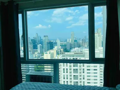 a bedroom window with a view of a city at Makati Penthouse with Stunning City Skyline View in Manila
