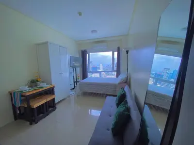 a bedroom with a bed and a view of a city at Makati Penthouse with Stunning City Skyline View in Manila