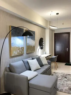a living room with a couch and a table at Amazing Unit and View in Uptown Parksuites BGC in Manila