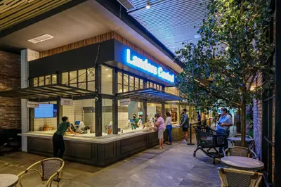 people standing around a food court in a building at Amazing Unit and View in Uptown Parksuites BGC in Manila