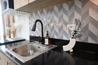 a stainless steel sink in a kitchen with a counter at Staycation near Mall of Asia, Condotel with King Bed in Manila