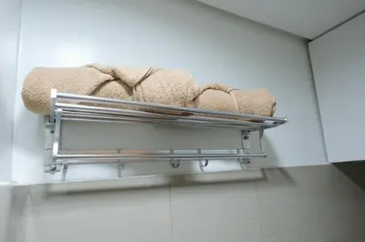 a towel rack in a bathroom with towels at Staycation near Mall of Asia, Condotel with King Bed in Manila