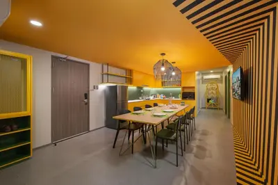 a kitchen with a table and chairs and a refrigerator at lyf Malate Manila managed by The Ascott Limited in Manila