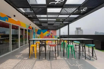 a group of tables and chairs on a patio at lyf Malate Manila managed by The Ascott Limited in Manila