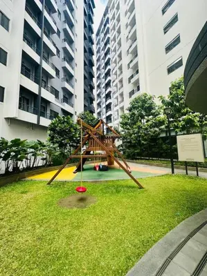 a sculpture in the middle of a park with tall buildings at Jeced Condotel at Spring Residences near Airport in Manila