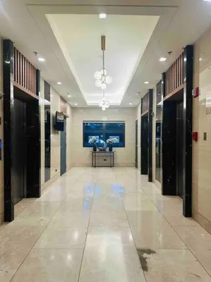 a hallway in a building with a large painting on the wall at Jeced Condotel at Spring Residences near Airport in Manila