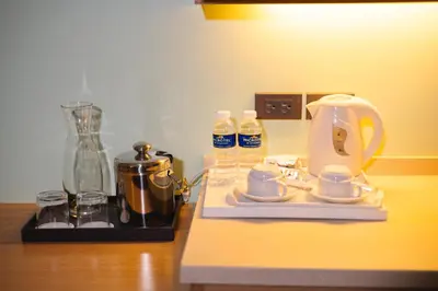 a counter with a coffee maker and bottles of water at Microtel by Wyndham South Forbes near Nuvali in Santa Rosa