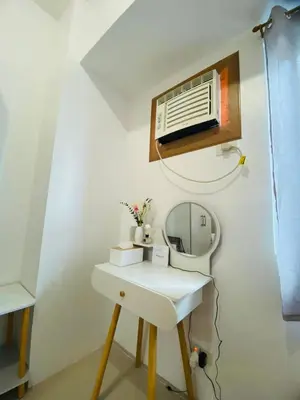 a bathroom with a mirror and a dressing table at Casa Lim SMDC Light Residences Tower 3 in Manila