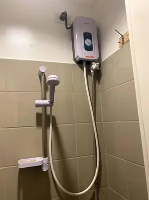 a shower in a bathroom with a soap dispenser at El Pueblo Studio - Manila in Manila