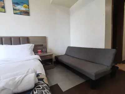 a bedroom with a bed and a bench in it at passion makati in Manila