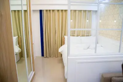 a bedroom with a white bed and a large mirror at Sea Residences - Classy Unit Near Mall of Asia, Arena, Ayala, Ikea, Okada, SMX, PITX, Airport in Manila