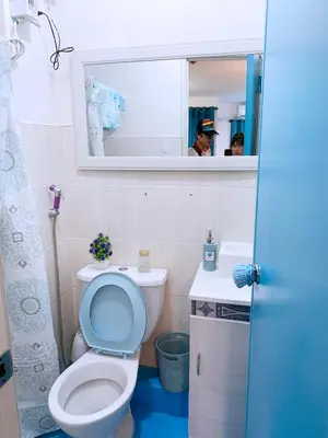 a bathroom with a toilet and a sink and a mirror at Blue Diamond Staycation beside Enchanted Kingdom in Santa Rosa Laguna in Santa Rosa