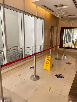 a lobby with a yellow sign on the floor at Condo near UP-PGH, St. Lukes Medical Center and U.S Embassy in Ermita Manila in Manila