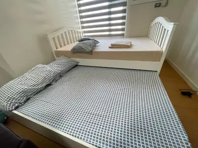 a couple of beds in a room with a window at Condo near UP-PGH, St. Lukes Medical Center and U.S Embassy in Ermita Manila in Manila