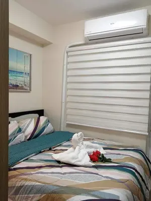 a bedroom with a bed with a towel on it at The SPARKLE Comfortable living by Awsom Phil in Manila
