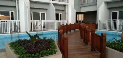 a row of pews in a church with a pool at The SPARKLE Comfortable living by Awsom Phil in Manila