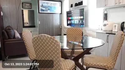 a glass table and chairs in a kitchen at The SCENIC: Comfortable living by Awsom Phil in Manila