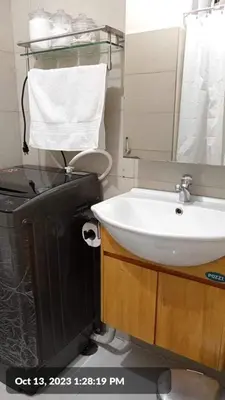 a bathroom with a sink and a toilet and a television at The SCENIC: Comfortable living by Awsom Phil in Manila