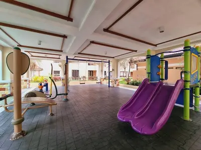 a playground with a purple slide in a room at Newport's STAR at Montecito Residential Resort in Manila