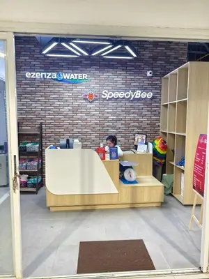 a child is sitting at a counter in a store at Sea Residences 5mins walk to SM MoA, Arena, SMX, 55