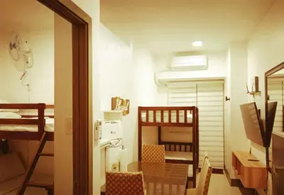 a small room with two bunk beds and a hallway at The ICONIC: Comfortable living by Awsom Phil in Manila