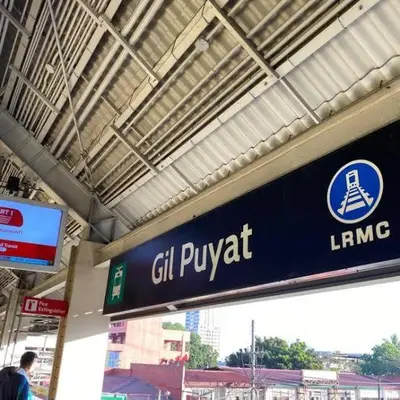 a sign for a gin puyat at a train station at Burgos Hub Hostel in Manila