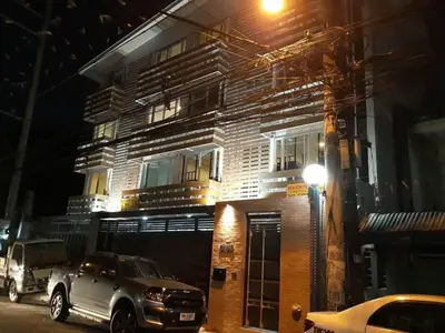 a truck parked in front of a building at night at Burgos Hub Hostel in Manila