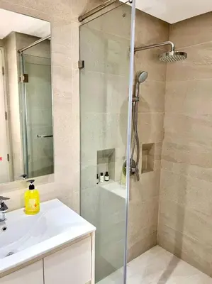 a bathroom with a shower with a sink and a shower at Luxury Studio in heart of Ortigas w/ swimming pool in Manila