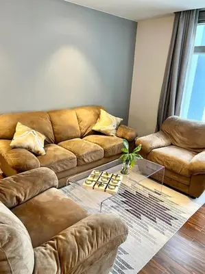 a living room with a couch and a coffee table at 3BR luxury apartment in Ortigas with swimming pool in Manila