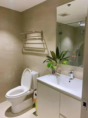 a bathroom with a toilet and a sink at 3BR luxury apartment in Ortigas with swimming pool in Manila