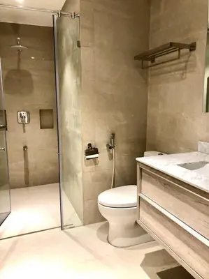a bathroom with a shower and a toilet and a sink at 3BR luxury apartment in Ortigas with swimming pool in Manila