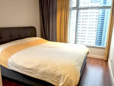 a bedroom with a bed and a large window at 3BR luxury apartment in Ortigas with swimming pool in Manila