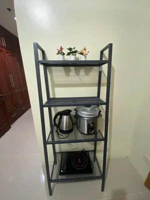 a shelf with a pot and a camera on it at Sea Residences MOA by Ruffa's Condotel in Manila
