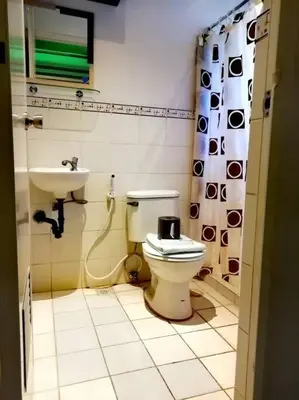 a bathroom with a toilet and a sink at Condo near NAIA Terminals Fasanvej Studio Netflix in Manila