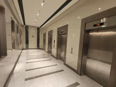an empty hallway with elevators in a building at 81 Newport C5 10i Balcony & Pool across NAIA T3 in Manila