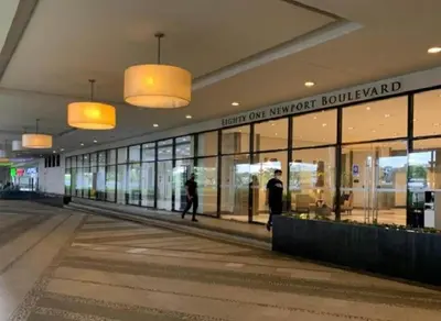 a shopping mall with people walking in front of windows at 81 Newport C5 10i Balcony & Pool across NAIA T3 in Manila