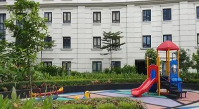 a playground in front of a building at 81 Newport C5 10i Balcony & Pool across NAIA T3 in Manila