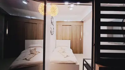 a room with two beds and a mirror at Stunning 1-Bedroom Condo in Manila