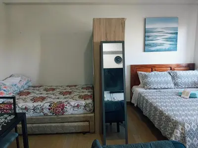 a bedroom with two beds and a mirror at Happy Stays A - 300mbps - 65
