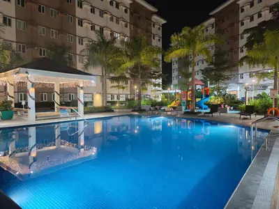a large swimming pool at night with a playground at Happy Stays A - 300mbps - 65