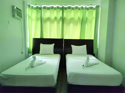 two beds in a room with white sheets and white pillows at SULIT CONDO Unit 2 Santa Mesa Manila in Manila