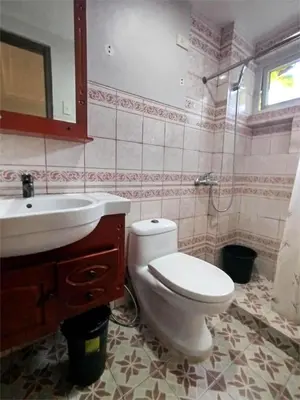 a bathroom with a toilet and a sink and a mirror at SULIT CONDO Unit 2 Santa Mesa Manila in Manila